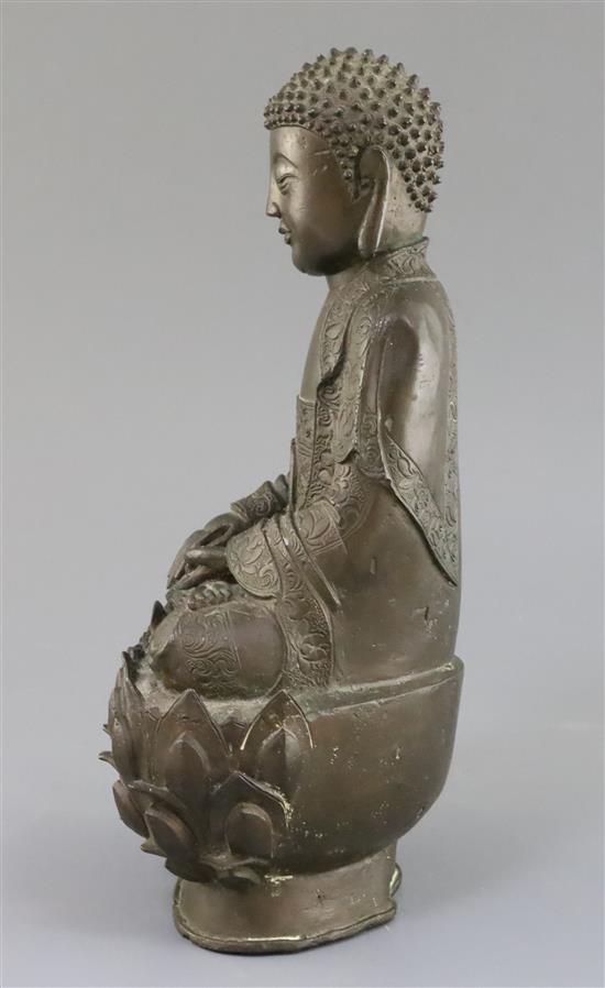 A Chinese bronze seated figure of Buddha Shakyamuni, 17th century, H. 32cm